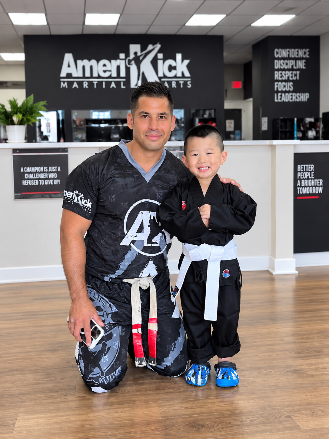 An AmeriKick South Philadelphia instructor supporting a young student