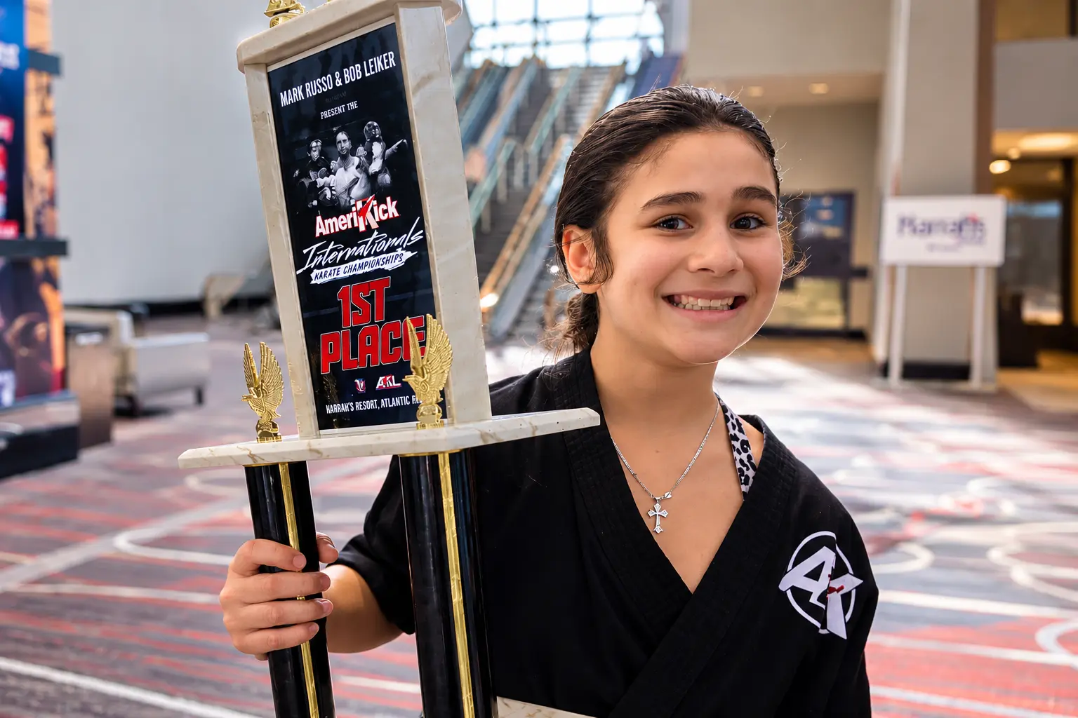 AmeriKick South Philadelphia student proudly holding a first-place trophy